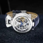Elegant skeleton mechanical watch with visible gears and blue accents, showcasing intricate craftsmanship and modern design.