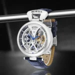 Close-up of a skeleton mechanical watch with visible gears and blue accents, showcasing intricate watchmaking craftsmanship.