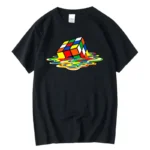 A colorful Rubik's Cube design appears to be melting into a vibrant, watercolor-style puddle on a black T-shirt.