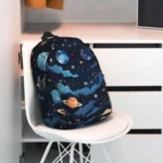 Space-themed children's backpack featuring planets, stars, and cosmic clouds, perfect for school or travel.
