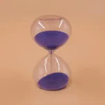 Elegant glass hourglass timer with purple sand, perfect for science demonstrations, home decor, or as an educational toy.
