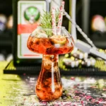 A vibrant, science-themed cocktail served in a laboratory-style glass with garnishes, perfect for science decor and educational toy displays.