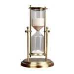 Elegant sand timer with white sand in a glass and brass frame, ideal for science decor and educational demonstrations.