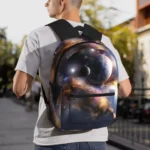 Youth wearing a galaxy-themed space backpack outdoors, showcasing a vibrant cosmic design with planets and stars.