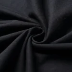 Black fabric swatch with a smooth, matte finish, twisted to showcase its texture and flexibility. Perfect for science-themed decor or educational projects.