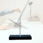 Modern kinetic sculpture with rotating metal rods on a black base, demonstrating principles of physics and motion.