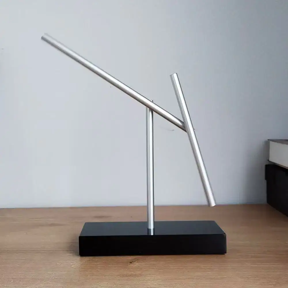 Magnetic Balance Science Toy Innovative magnetic balance sculpture demonstrating physics principles with sleek metal rods on a black base. Perfect for educational displays and science enthusiasts.