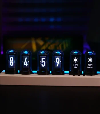 Modern digital clock with Nixie tube style display showing time and weather forecast icons, set on a white base against a dark background.