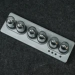 A sleek magnetic ball puzzle toy with six shiny metallic spheres on a gray base, designed for brain teasers and educational entertainment.