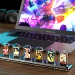 Colorful LED display with miniature sports figures and a laptop in the background.