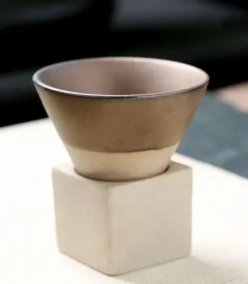 Elegant ceramic bowl on a white cube stand, ideal for science-themed decor or educational displays.