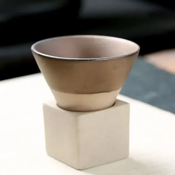 Elegant ceramic bowl on a white cube stand, ideal for science-themed decor or educational displays.
