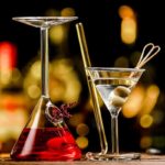 Laboratory glassware with colorful liquids and scientific tools on a blurred background.
