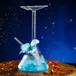 A vibrant science experiment featuring a conical flask filled with blue liquid, a glass stirrer, and colorful splashes, perfect for educational decor and science toys.