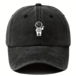 Black baseball cap featuring a small astronaut graphic with a helmet and space suit, perfect for science enthusiasts and space lovers.