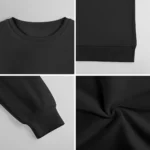 Close-up of a plain black crewneck sweatshirt showing the neckline, sleeve cuff, and fabric texture on a light background.