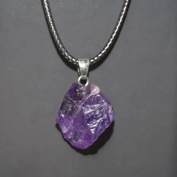 Amethyst crystal pendant necklace with a silver chain, showcasing a raw purple gemstone. Perfect for science-inspired jewelry and educational gift ideas.