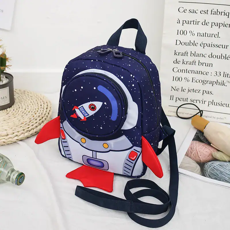 Space-themed children's backpack with rocket and galaxy design, perfect for young explorers. Backpack with a space rocket and galaxy print, ideal for kids interested in science and space adventures.