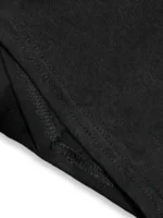Close-up of black fabric showing smooth texture and stitched hem of a casual T-shirt.