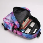 Colorful galaxy-themed backpack open with school supplies including notebooks, a mouse, and a phone inside, ideal for students.