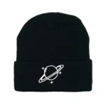 Black beanie hat featuring a white space planet with rings and stars, perfect for science enthusiasts and space lovers.