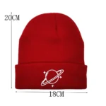 Red science-themed beanie hat with planet and star design.