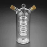 Glass spiral distillation apparatus with cork stoppers, used for chemistry experiments.