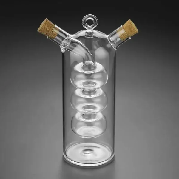 Glass spiral distillation apparatus with cork stoppers, used for chemistry experiments.