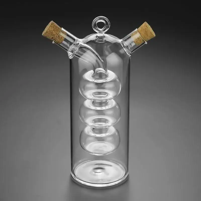 Glass spiral distillation apparatus with cork stoppers, used for chemistry experiments.