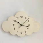 Modern cloud-shaped wall clock featuring black numerals and hands, perfect for children's rooms or playful decor. Easy to read and adds a whimsical touch to any space.