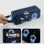 Space-themed pencil case with astronaut and rocket charms, perfect for science enthusiasts.