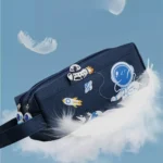 Colorful space-themed pencil case featuring an astronaut, rocket, and planets design, set against a soft blue background with floating feathers.