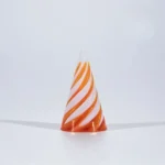 Orange and white spiral swirl test tube or cone-shaped object on a white background.