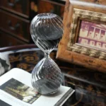 Elegant glass sand timer with spiral pattern, ideal for science-themed decor and educational demonstrations.