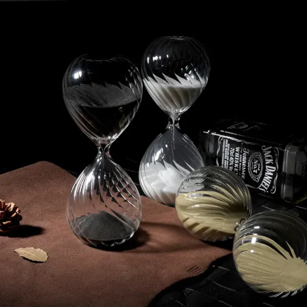 Elegant set of hourglass-shaped glassware with black and white swirling patterns, ideal for science experiments, educational demonstrations, or stylish home decor.