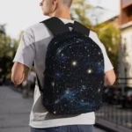 Youth wearing a galaxy-themed starry sky backpack outdoors, showcasing a stylish and educational accessory with celestial patterns.