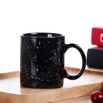 Black ceramic mug with white star and constellation design, perfect for science and astronomy enthusiasts.
