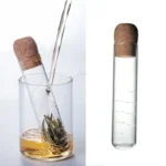 Test tube with cork stopper and tea leaves in water, demonstrating scientific experiment setup.