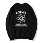 Black sweatshirt featuring a colorful atomic model graphic with the phrase "Science Doesn't Care What You Believe" in bold white letters, perfect for science enthusiasts.