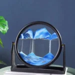 An artistic science decor piece featuring a circular frame with a mountain landscape and cascading waterfalls, simulating a miniature mountain scene with flowing water.