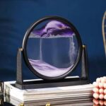 Magnetic levitation science toy demonstrating floating and spinning effects with a circular magnet and colorful liquid inside a glass frame.