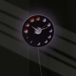 LED moon phases wall clock showing different lunar phases with illuminated design.