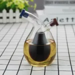Laboratory glassware with a dual-neck design containing dark and light liquids, used for scientific experiments and educational demonstrations.