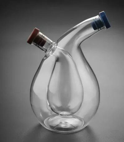 An elegant glass laboratory container featuring two angled openings with colored caps, ideal for science experiments and educational demonstrations.