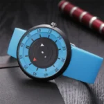 A modern stopwatch with a blue strap and black dial, featuring a unique circular design for precise time measurement, placed on a dark surface.