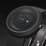 Modern minimalist watch with geometric shapes on the dial, featuring a sleek black strap and a round face with abstract markers.