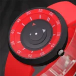 An image of a mechanical countdown timer featuring a red dial with white markings and a black outer frame, used for precise time measurement in science experiments and cooking.