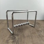 Newton's Cradle metal ball set for demonstrating conservation of momentum and energy.