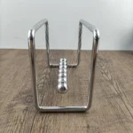 Classic magnetic Newton's cradle demonstrating physics principles with metal balls on a wooden surface.