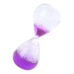 Hourglass with purple and clear sand in motion.